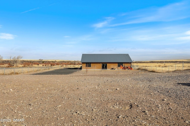 view of outbuilding with fence and a rural view