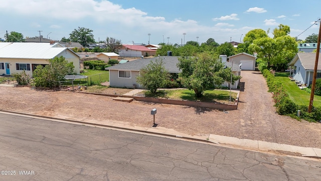 260 E 1st St, Snowflake, AZ 85937 - view of front of home featuring a residential view, a detached garage, and dirt driveway