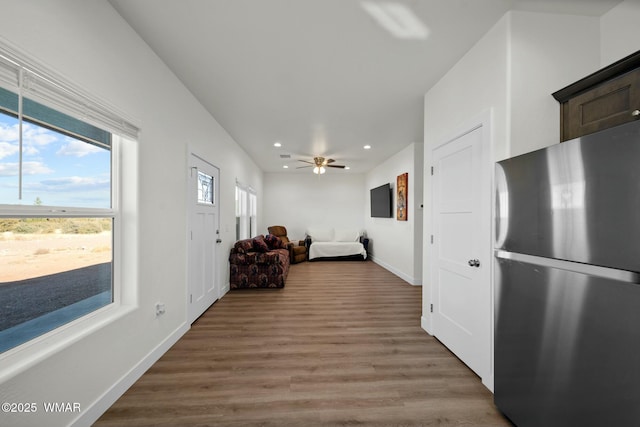 interior space featuring recessed lighting, freestanding refrigerator, ceiling fan, wood finished floors, and baseboards