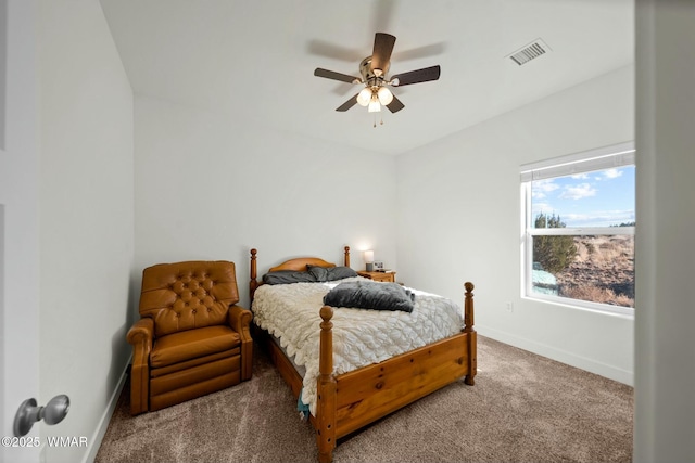 carpeted bedroom with a ceiling fan, visible vents, and baseboards