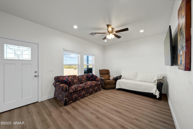 living area featuring ceiling fan, baseboards, wood finished floors, and recessed lighting