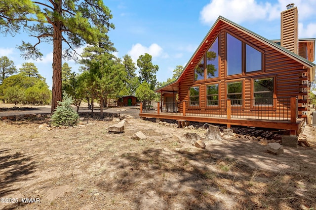 1464 Low Mountain Trl, Heber, AZ 85928 - rear view of property with a wooden deck, a chimney, log exterior, and a storage unit