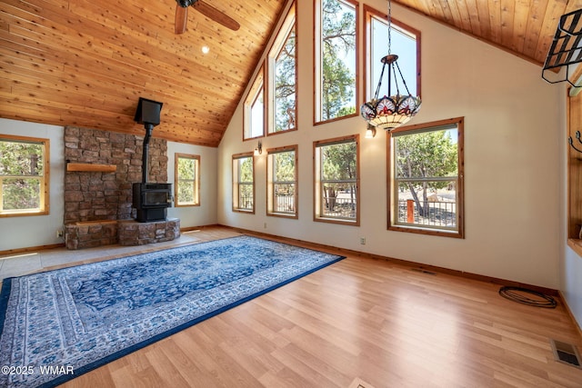 1464 Low Mountain Trl, Heber, AZ 85928 - unfurnished living room with wood ceiling, high vaulted ceiling, a wood stove, baseboards, and a ceiling fan