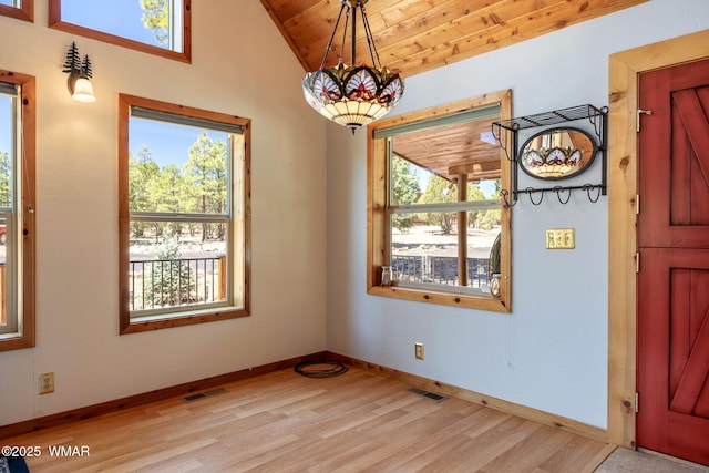 1464 Low Mountain Trl, Heber, AZ 85928 - unfurnished dining area featuring light wood-type flooring, wood ceiling, vaulted ceiling, baseboards, and a chandelier