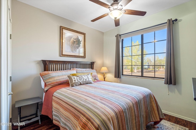 bedroom with wood finished floors, baseboards, and a ceiling fan