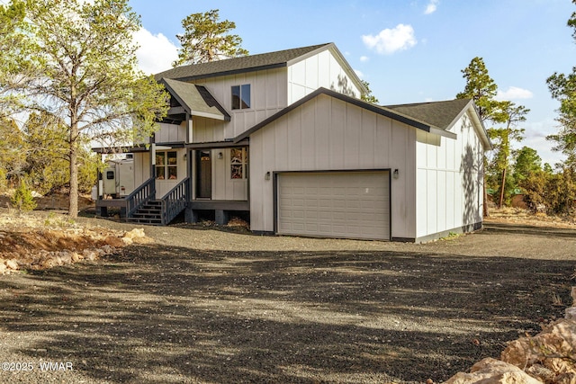 view of front of house with a porch, a garage, roof with shingles, and driveway