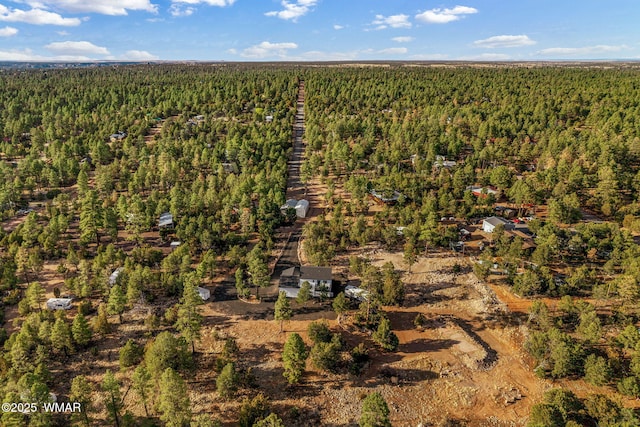 birds eye view of property with a forest view