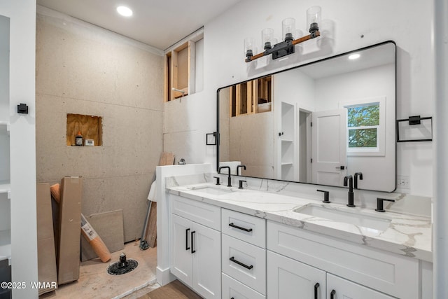 bathroom with double vanity, recessed lighting, and a sink