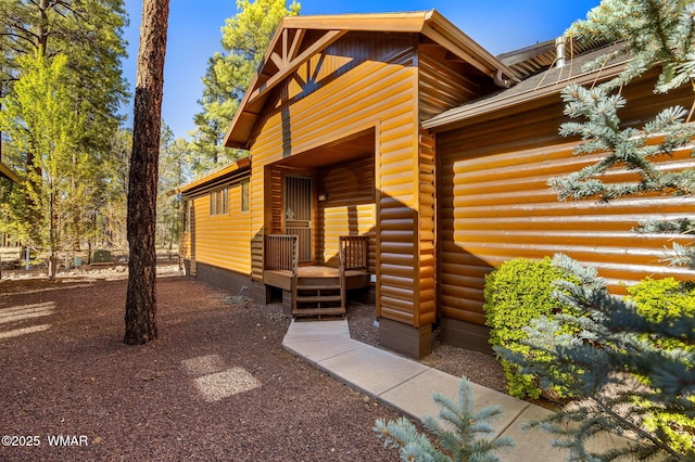 4186 Stone Pine Dr, Pinetop, AZ 85935 - doorway to property featuring faux log siding and a deck