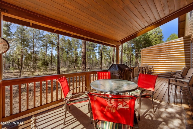 4186 Stone Pine Dr, Pinetop, AZ 85935 - wooden deck featuring grilling area, outdoor dining area, and view of wooded area