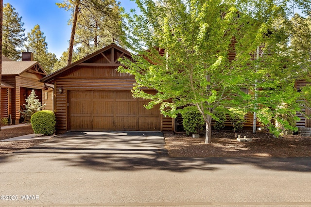 4186 Stone Pine Dr, Pinetop, AZ 85935 - log cabin featuring asphalt driveway and an attached garage
