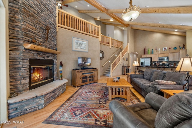 4186 Stone Pine Dr, Pinetop, AZ 85935 - living area featuring wood finished floors, beam ceiling, stairs, recessed lighting, and a fireplace