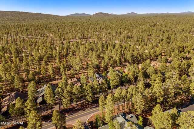 4186 Stone Pine Dr, Pinetop, AZ 85935 - drone / aerial view of a heavily wooded area and a mountainous background