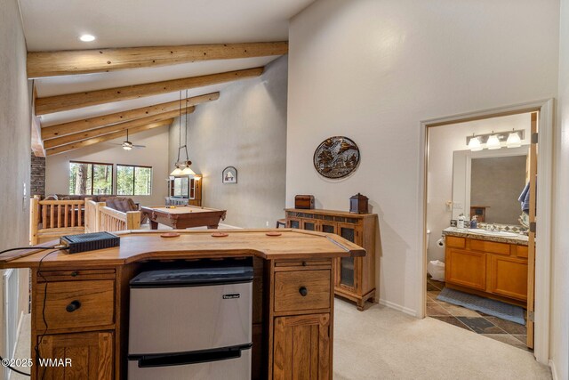 4186 Stone Pine Dr, Pinetop, AZ 85935 - kitchen featuring freestanding refrigerator, wooden counters, beamed ceiling, light colored carpet, and brown cabinetry