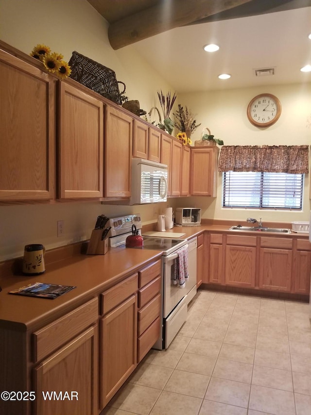 kitchen with light tile patterned flooring, recessed lighting, white appliances, a sink, and visible vents