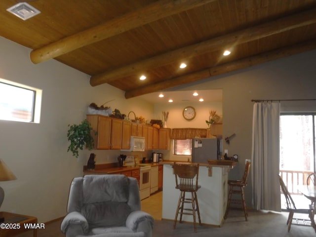 kitchen featuring lofted ceiling with beams, a peninsula, white appliances, a breakfast bar, and wood ceiling