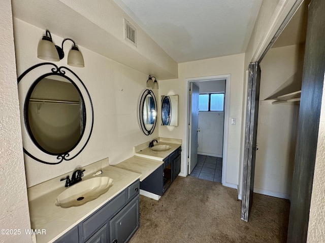 7124 Simons Way, Show Low, AZ 85901 - bathroom featuring two vanities and baseboards