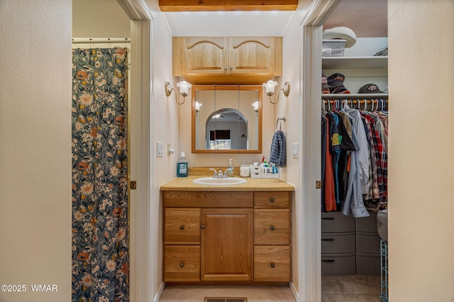 1720 W Huning, Show Low, AZ 85901 - bathroom featuring vanity and a walk in closet