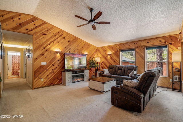 1720 W Huning, Show Low, AZ 85901 - living area with plenty of natural light, a ceiling fan, wooden walls, vaulted ceiling, and light carpet