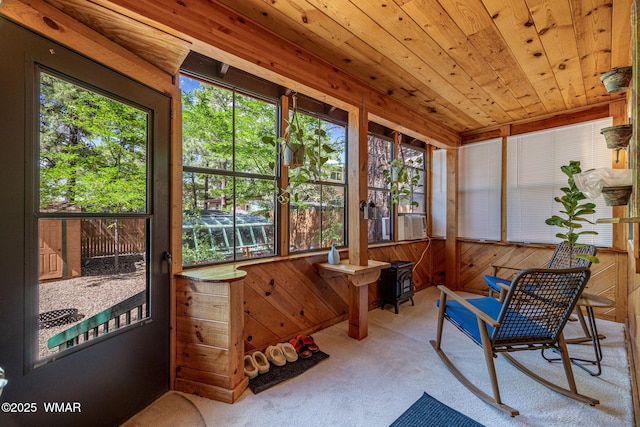 1720 W Huning, Show Low, AZ 85901 - sunroom / solarium featuring carpet flooring, wooden walls, wooden ceiling, a wood stove, and cooling unit
