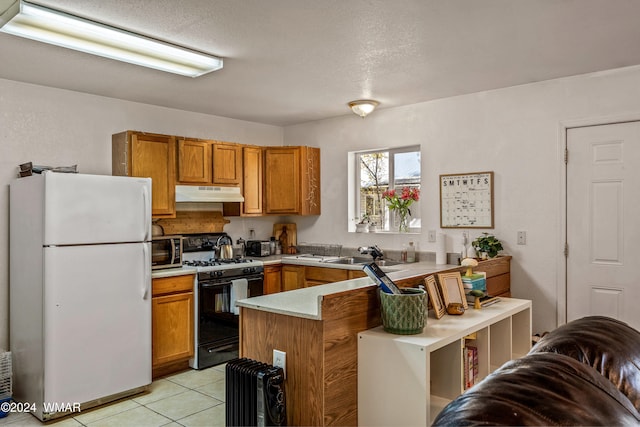 55 E Central Ave, Eagar, AZ 85925 - kitchen featuring black gas range, under cabinet range hood, a peninsula, light countertops, and freestanding refrigerator