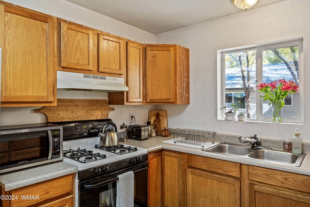 55 E Central Ave, Eagar, AZ 85925 - kitchen featuring range with gas cooktop, light countertops, a sink, and under cabinet range hood