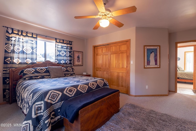 carpeted bedroom featuring multiple windows, baseboards, a closet, and ceiling fan