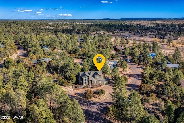 birds eye view of property featuring a view of trees