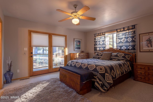 bedroom featuring carpet flooring, access to outside, multiple windows, and visible vents