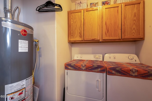 laundry area featuring gas water heater, cabinet space, and washing machine and clothes dryer