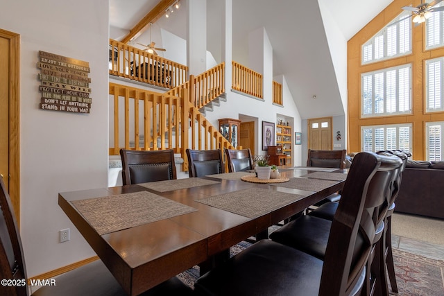 dining room with a healthy amount of sunlight, stairs, and ceiling fan