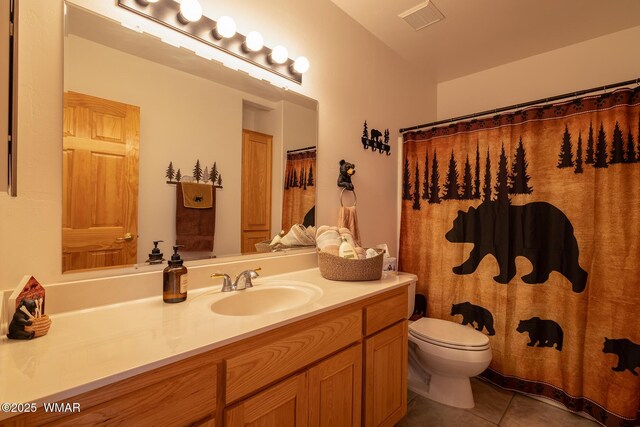 bathroom featuring visible vents, toilet, vanity, and tile patterned flooring