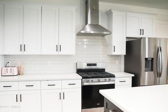 kitchen featuring wall chimney exhaust hood, appliances with stainless steel finishes, and light countertops