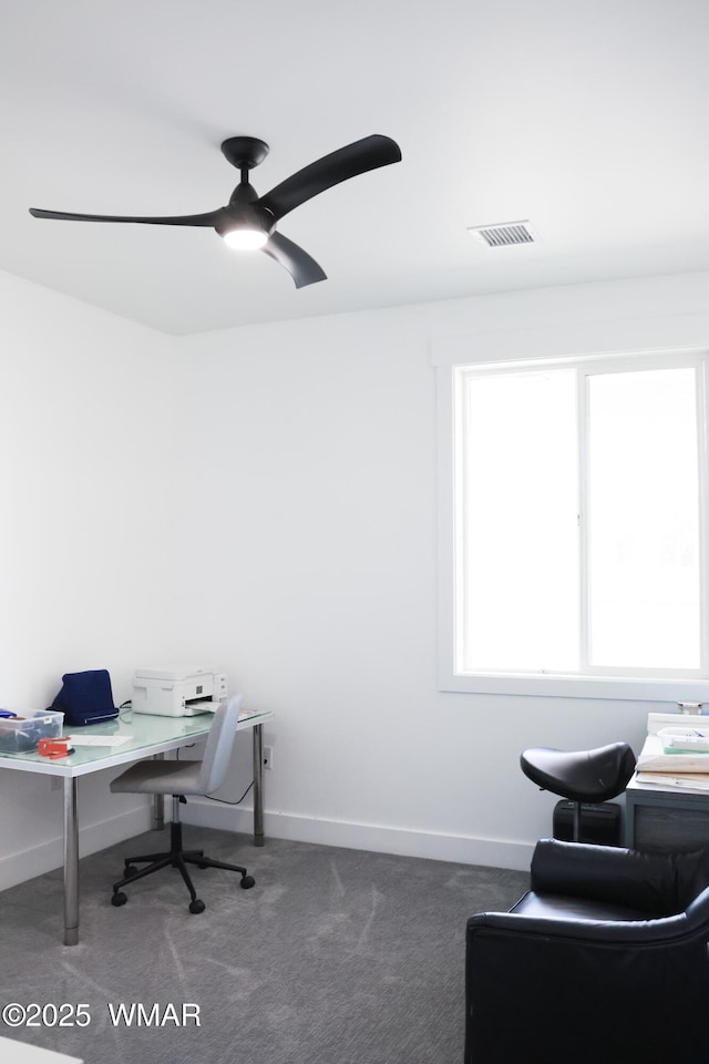 carpeted office with visible vents, ceiling fan, and baseboards