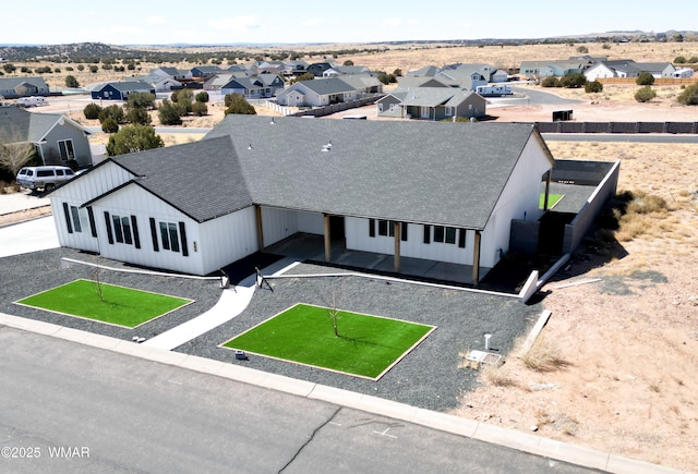 birds eye view of property with a residential view