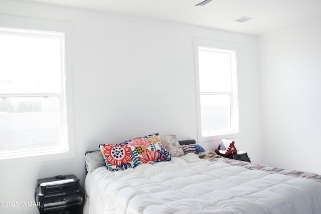 bedroom featuring visible vents