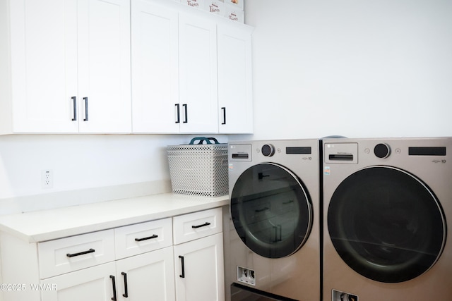 laundry room with separate washer and dryer and cabinet space