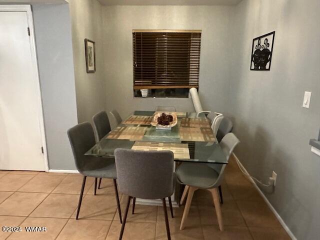 dining area with light tile patterned floors and baseboards