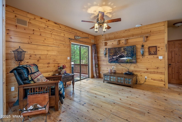 2353 Florian Meadow Trl, Overgaard, AZ 85933 - living room with ceiling fan, wood-type flooring, and wood walls