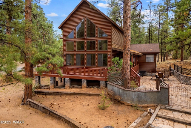 2353 Florian Meadow Trl, Overgaard, AZ 85933 - rear view of house with faux log siding, a wooden deck, a patio, and roof with shingles
