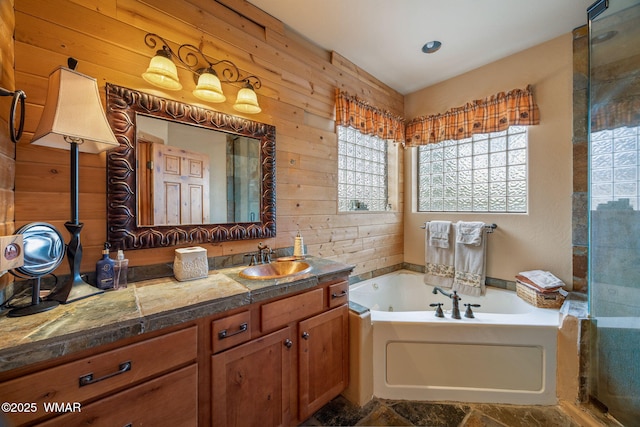 2353 Florian Meadow Trl, Overgaard, AZ 85933 - bathroom featuring a jetted tub, vanity, wooden walls, a shower stall, and stone finish flooring