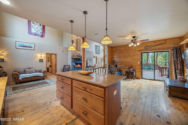 2353 Florian Meadow Trl, Overgaard, AZ 85933 - kitchen featuring open floor plan, wooden walls, light wood-style floors, and a kitchen island