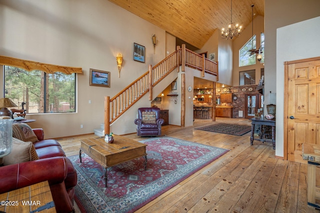 2353 Florian Meadow Trl, Overgaard, AZ 85933 - living room featuring high vaulted ceiling, plenty of natural light, wood-type flooring, stairs, and a chandelier
