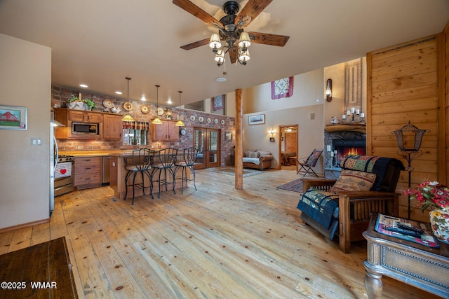 2353 Florian Meadow Trl, Overgaard, AZ 85933 - living area featuring ceiling fan, light wood-type flooring, a stone fireplace, and recessed lighting