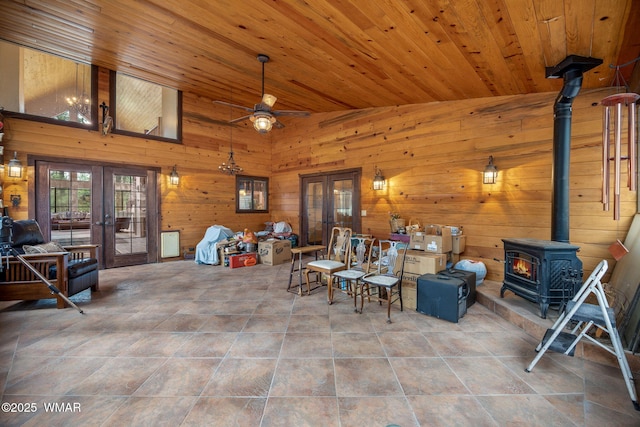 2353 Florian Meadow Trl, Overgaard, AZ 85933 - living area featuring french doors, a wood stove, wood walls, a ceiling fan, and wood ceiling