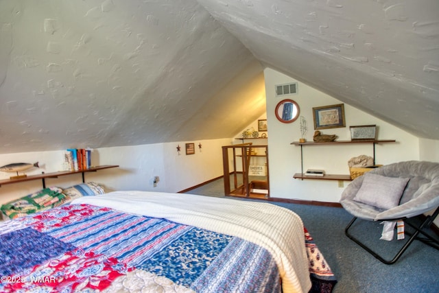 bedroom featuring a textured ceiling, baseboards, visible vents, and carpet floors