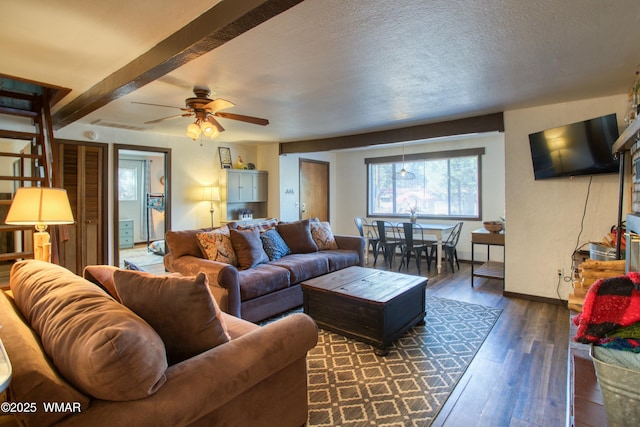 living room with visible vents, baseboards, ceiling fan, a textured ceiling, and dark wood-style floors