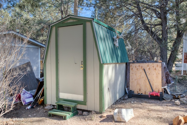 view of shed featuring fence