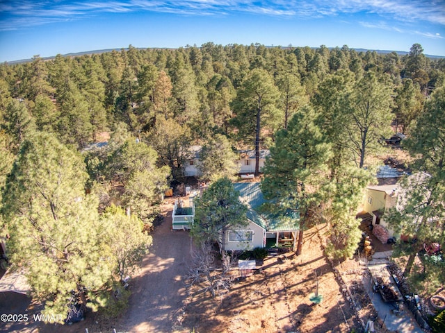 bird's eye view featuring a wooded view