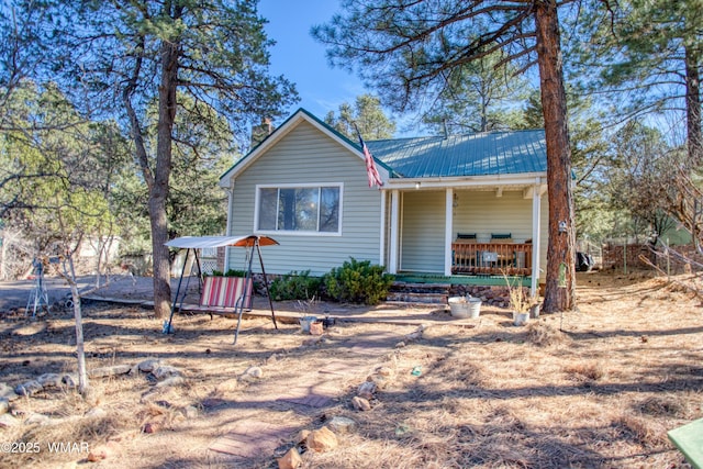 back of property featuring metal roof and covered porch